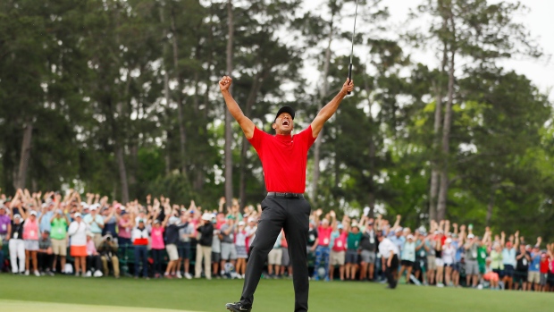 Tiger Woods of the United States celebrates with the Masters Trophy during the Green Jacket Ceremony after winning the Masters at Augusta National Golf Club on April 14, 2019.