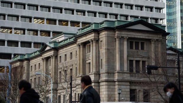 Pedestrians walk past the Bank of Japan (BOJ) headquarters in Tokyo, Japan, on Monday, March 11, 2019. 