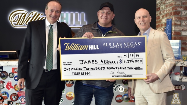 James Adducci holds a ceremonial check at the William Hill Sports Book at SLS Las Vegas Hotel. Photographer: David Becker/Getty Images for William Hill US