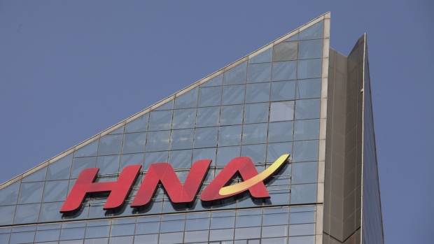 Signage for HNA Group Co. is displayed atop the company's building in Beijing, China, on Thursday, Feb. 1, 2018. Companies linked to HNA have secured 7.8 billion yuan ($1.2 billion) in long-term loans from Chinese banks to finance an expansion project in Meilan Airport in HNA's home province of Hainan. 