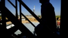 The silhouette of a contractor is seen walking up stairs at an Anadarko Petroleum Corp. oil rig site in Fort Lupton, Colorado. 