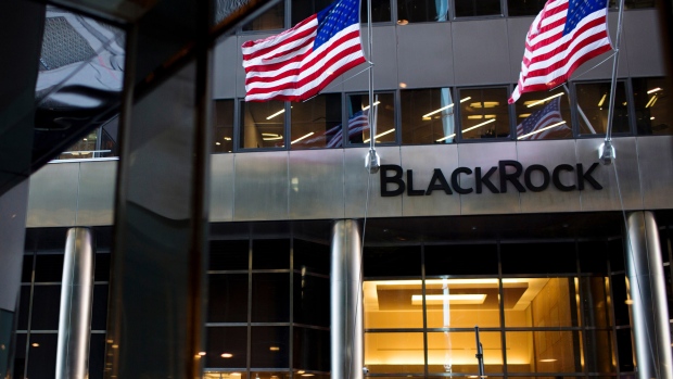 Pedestrians pass in front of BlackRock Inc. headquarters in New York.