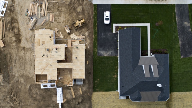 A house under construction stands next to a completed home at the Toll Brothers Inc. Bowes Creek Country Club community in this aerial photograph taken over Elgin, Illinois, U.S. 