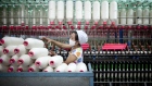A worker manufactures cotton yarn at a factory in Dali county, Shaanxi province, China, on Wednesday, April 27, 2011. China, the largest cotton importer, cancelled orders for more than 100,000 bales in April after heavy buying in March, according to the U.S. Department of Agriculture. 