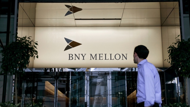 A pedestrian passes in front of a Bank of New York Mellon Corp. office building in New York, U.S. 