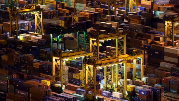 Stacked containers sit among gantry cranes illuminated at night at Tanjong Pagar Container Terminal, operated by PSA International Pte, at the Port of Singapore in Singapore, on Thursday, Sept. 15, 2016. Singapore's non-oil exports - the most commonly-used gauge for trade performance – are estimated to fall 3.1 percent in August after they dropped 10.6 percent in July from a year earlier. 