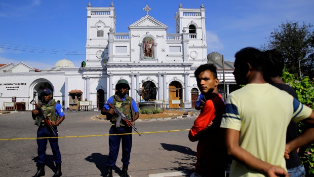 Sri Lankans gather outside St. Anthony's Shrine a day after the series of blasts, in Colombo.