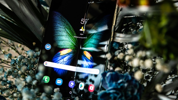 An attendee holds a Samsung Electronics Co. Galaxy Fold mobile device Photographer: Jeenah Moon/Bloomberg