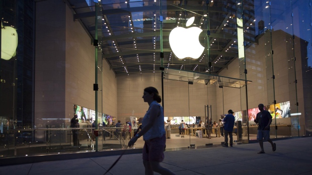 Pedestrians pass in front of the Apple Inc. store on Manhattan's Upper West Side in New York. 