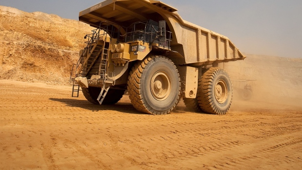 A Caterpillar Inc. mining truck leaves for the processing plant after collecting newly-excavated ore from the open pit at Katanga Mining Ltd.\'s KOV copper and cobalt mine in Kolwezi, Katanga province, Democratic Republic of Congo, on Wednesday, Aug. 1, 2012. 
