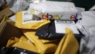 A parcel in eBay Inc. packaging is seen on a conveyor belt with other small parcels at the United States Postal Service (USPS) sorting center in Louisville, Kentucky, U.S., on Friday, Jan. 13, 2017. Starting January 22, the cost of mailing a one-ounce first-class letter will return to being 49 cents, up from 47 cents, where it had been since April. 