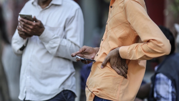 People use smartphones in Mumbai, India, on Friday, March 28, 2019. Based on the early tallies, as many as 60 percent of India’s 900 million eligible voters are expected to cast ballots between now and May 19, as the center-left Congress Party tries to seize power from the right-wing Bharatiya Janata Party. As in other elections around the world, paid hacks and party zealots are churning out propaganda on Facebook Inc. and the company's WhatsApp messenger, along with Twitter, YouTube, TikTok, and other ubiquitous communication channels. 