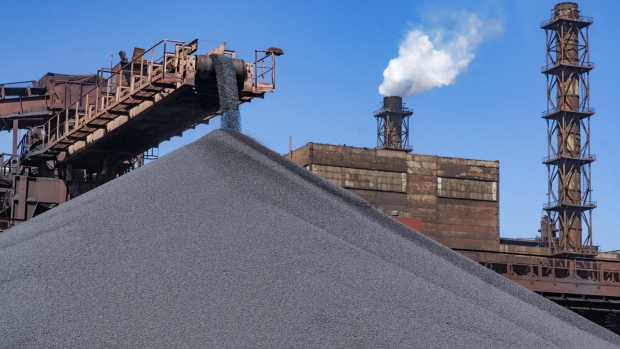 A conveyor belt drops iron ore pellets onto an outdoor storage pile at the Yeristovo and Poltava iron ore mine, operated by Ferrexpo Poltava Mining PJSC, in Poltava, Ukraine, on Friday, May 5, 2017. China accounted for over 60% of global iron-ore demand in 2016, World Steel Association data show and was Ferrexpo's largest export-sales contributor by country. 