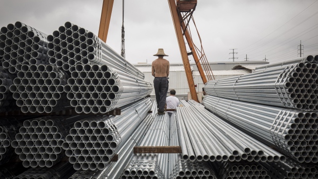 Workers prepare to lift bundles of steel pipe with a crane at a stockyard on the outskirts of Shanghai, China, on Thursday, July 5, 2018. U.S. President Donald Trump’s attempts to re-balance global trade have already sent the metals world into a tizzy. As countries respond to U.S. tariffs and sanctions, the disarray is set to increase. Photgrapher: Qilai Shen/Bloomberg