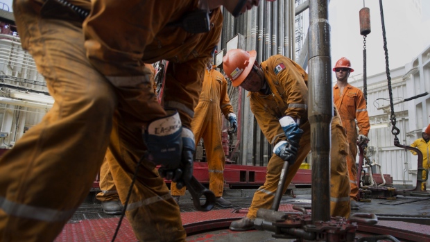 Workers prepare drilling pipe on the Petroleos Mexicanos (Pemex) La Muralla IV deep sea crude oil platform in the waters off Veracruz, Mexico, on Friday, Aug. 30, 2013. 