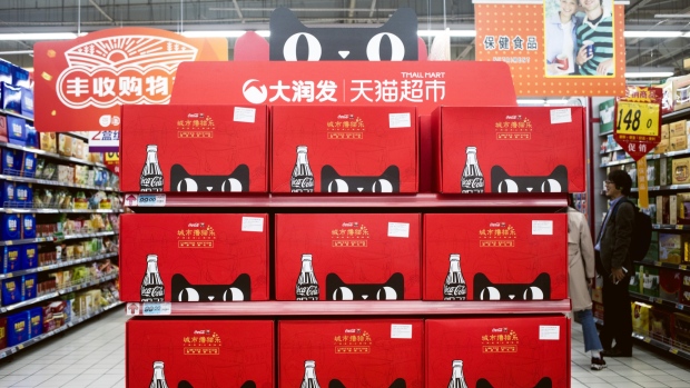 The Tmall Cat mascot for Alibaba Group Holding Ltd.'s Tmall online marketplace is displayed on boxes of Coca-Cola Co. products inside an RT-Mart hypermarket operated by Sun Art Retail Group Ltd., backed by Alibaba, Auchan Retail International S.A. and Ruentex Group, in Shanghai, China, on Sunday, Nov. 11, 2018. Alibaba logged 10 billion yuan ($1.44 billion) in sales in the opening minutes of its annual Singles' Day extravaganza, outpacing last year’s start and on pace to smash a record as shoppers swarmed the e-commerce giant’s online bazaars. 