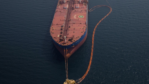 Pipes feed crude oil to the 'Xin Run Yang' oil tanker, operated by Cosco Shipping Holdings Co., during loading operations near the Ras Tanura oil refinery, in Res Tanura, Saudi Arabia. 