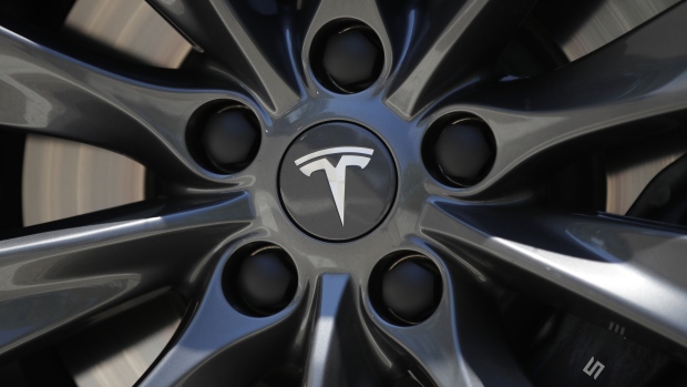 A Tesla logo sits on the wheel hub of a Tesla Inc. Model S electric vehicle at a Supercharger station in Egerkingen, Switzerland, on Thursday, Aug. 16, 2018. 