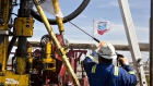 A Chevron Corp. flag flies on the drilling floor of a Nabors Industries Ltd. drill rig in the Permian Basin near Midland, Texas, U.S., on Thursday, March 1, 2018. Chevron, the world's third-largest publicly traded oil producer, is spending $3.3 billion this year in the Permian and an additional $1 billion in other shale basins. Its expansion will further bolster U.S. oil output, which already exceeds 10 million barrels a day, surpassing the record set in 1970. 