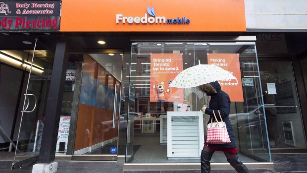 A women walks past the new rebranding sign of Freedom Mobile in Toronto, November 24, 2016. 