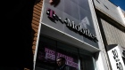 Pedestrians pass in front of a T-Mobile US Inc. store in New York, U.S. on Monday, April 30, 2018. Sprint Corp. suffered its worst stock decline in almost six months, rocked by fears that a proposed $26.5 billion takeover by T-Mobile US Inc. will get rejected by antitrust enforcers. 