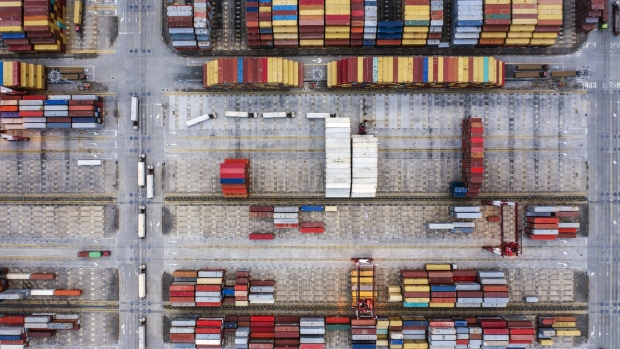 Shipping containers sit stacked at the Yangshan Deepwater Port, operated by Shanghai International Port Group Co. (SIPG), in this aerial photograph taken in Shanghai, China, on Friday, May 10, 2019. The U.S. hiked tariffs on more than $200 billion in goods from China on Friday in the most dramatic step yet of President Donald Trump's push to extract trade concessions, deepening a conflict that has roiled financial markets and cast a shadow over the global economy. 