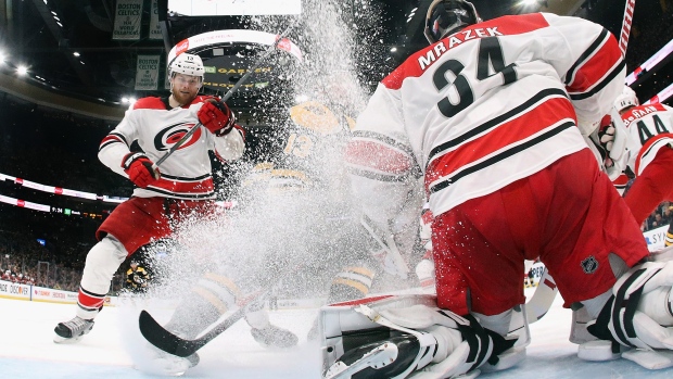 Warren Foegele #13 and Petr Mrazek #34 of the Carolina Hurricanes defend the net against the Boston Bruins in Game One of the Eastern Conference Final during the 2019 NHL Stanley Cup Playoffs in Boston on May 09, 2019.