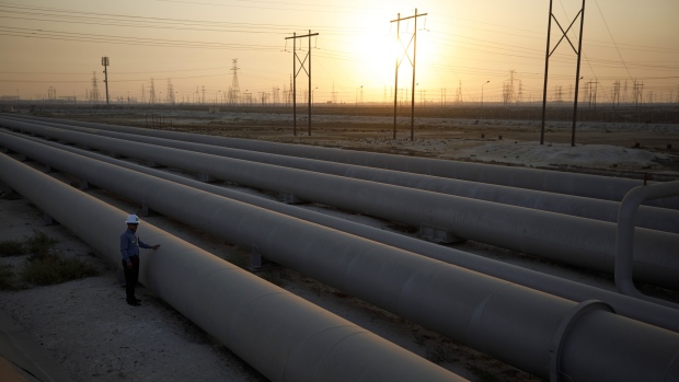 An employee inspects oil transport pipes at the Juaymah tank farm at Saudi Aramco's Ras Tanura oil refinery and oil terminal in Ras Tanura, Saudi Arabia, on Monday, Oct. 1, 2018.