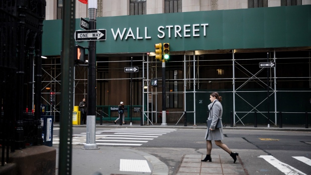 A pedestrian walks up Broadway near the New York Stock Exchange. 
