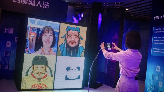 A woman demonstrates Baidu Inc.'s facial recognition system in an exhibition display at the Baidu World conference in Beijing, China, on Thursday, Nov. 1, 2018. Baidu showcased its artificial intelligence advancements and unveiled new products at the event. 