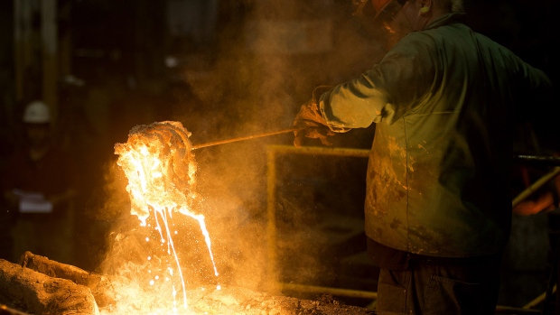 A worker removes slag, a stony waste substance created from the smelting process, from molten metal in a ladle at a facility in Salem, Ohio. 