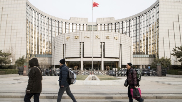 Pedestrians walk past the People's Bank of China headquarters in Beijing, China, on Monday, Jan. 7, 2019. The central bank on Friday announced another cut to the amount of cash lenders must hold as reserves in a move to release a net 800 billion yuan ($117 billion) of liquidity and offset a funding squeeze ahead of the Chinese New Year. 