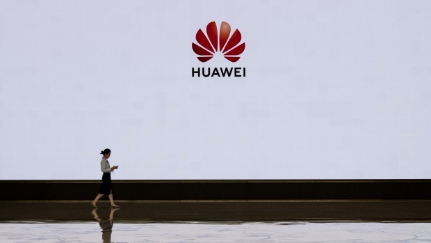 SHENZHEN, CHINA - APRIL 12: A member of Huawei's reception staff walks in front of a large screen displaying the logo in the foyer of a building used for high profile customer visits and displays at the company's Bantian campus on April 12, 2019 in Shenzhen, China. Huawei is Chinas most valuable technology brand, and sells more telecommunications equipment than any other company in the world, with annual revenue topping $100 billion U.S. Headquartered in the southern city of Shenzhen, considered Chinas Silicon Valley, Huawei has more than 180,000 employees worldwide, with nearly half of them engaged in research and development. In 2018, the company overtook Apple Inc. as the second largest manufacturer of smartphones in the world behind Samsung Electronics, a milestone that has made Huawei a source of national pride in China. While commercially successful and a dominant player in 5G, or fifth-generation networking technology, Huawei has faced political headwinds and allegations that its equipment includes so-called backdoors that the U.S. government perceives as a national security. U.S. authorities are also seeking the extradition of Huaweis Chief Financial Officer, Meng Wanzhou, to stand trial in the U.S. on fraud charges. Meng is currently under house arrest in Canada, though Huawei maintains the U.S. case against her is purely political. Despite the U.S. campaign against the company, Huawei is determined to lead the global charge toward adopting 5G wireless networks. It has hired experts from foreign rivals, and invested heavily in R&D to patent key technologies to boost Chinese influence. (Photo by Kevin Frayer/Getty Images)
