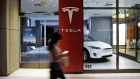 A pedestrian walks past a closed Tesla Inc. store in Palm Desert, California, U.S., on Thursday, March 7, 2019. 