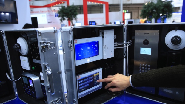 An exhibitor demonstrates a fingerprint scanning device on a display of Alhua Technology video intercom products in the Zheijiang Dahua Technology Co. Ltd. pavilion at the CeBIT 2017 tech fair in Hannover, Germany, on Tuesday, March 21, 2017. Leading edge technologies in the digital world are showcased in this annual event which runs March 20 - 24. 