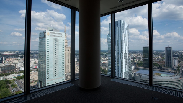 Towers stand on the city skyline seen from unoccupied office space in central Warsaw, Poland, on Monday, June 16, 2014. Poland may be forced to hold an early ballot as a scandal over leaked recordings of conversations among officials roils the nation, Prime Minister Donald Tusk said. 