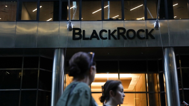 Pedestrians walk past BlackRock Inc. headquarters in New York. 