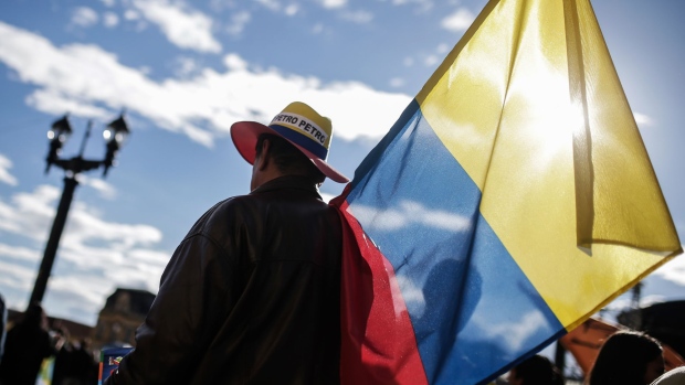 An attendee holds a Colombia national flag ahead of a campaign rally for Gustavo Petro, presidential candidate for the Progressivists Movement Party, in Bogota, Colombia, on Thursday, May 17, 2018. Colombians vote in the first round of elections on May 27, with a likely runoff on June 17. 
