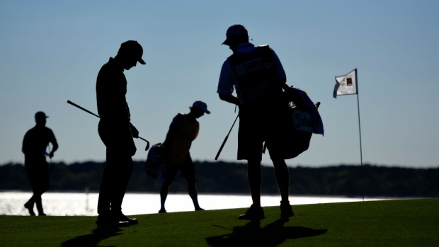 HILTON HEAD ISLAND, SOUTH CAROLINA - APRIL 21: (L-R) Scott Piercy, Patrick Cantlay, and their caddies look on from the 18th green during the final round of the 2019 RBC Heritage at Harbour Town Golf Links on April 21, 2019 in Hilton Head Island, South Carolina. (Photo by Jared C. Tilton/Getty Images)