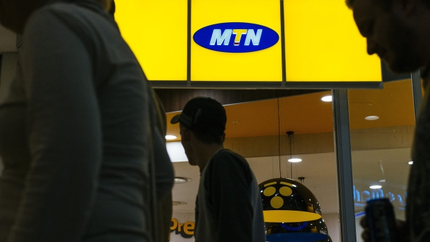 Shoppers pass the entrance to an MTN Group Ltd. telecommunications store at the Clearwater Mall in Johannesburg, South Africa, on Thursday, Aug. 3. 2017. MTN Group Ltd.said a Nigerian listing that it agreed to as part of a $1 billion regulatory fine was on track and would take place within the next six to 12 months. 
