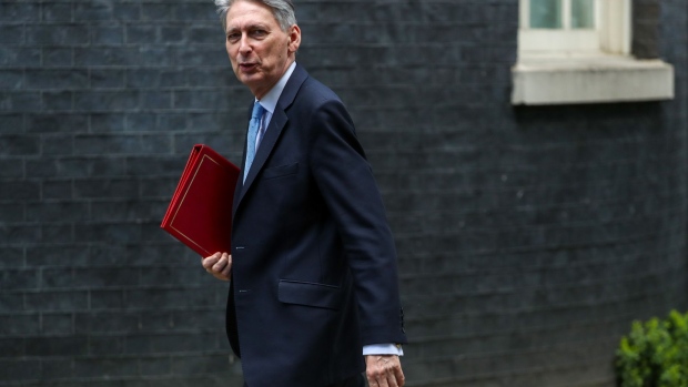 Philip Hammond, U.K. chancellor of the exchequer, departs number 11 Downing Street to attend a weekly questions and answers session in Parliament in London, U.K., on Wednesday, Nov. 14, 2018. U.K. Prime Minister Theresa May will ask her divided Cabinet ministers to back her Brexit deal or quit, as the U.K.’s divorce from the European Union enters its most dangerous phase yet. Photographer: Simon Dawson/Bloomberg