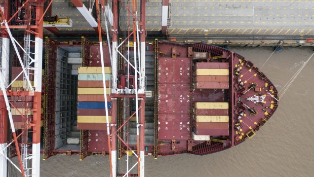 A container ship is docked next to gantry cranes at the Yangshan Deepwater Port, operated by Shanghai International Port Group Co. (SIPG), in this aerial photograph taken in Shanghai, China, on Friday, May 10, 2019. The U.S. hiked tariffs on more than $200 billion in goods from China on Friday in the most dramatic step yet of President Donald Trump's push to extract trade concessions, deepening a conflict that has roiled financial markets and cast a shadow over the global economy. 