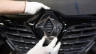 A worker attaches a Renault diamond badge to the front grille of an automobile on the production line inside the Renault SA automobile plant in Moscow, Russia, on Tuesday, May 28, 2019. A prospective deal proposed by Fiat Chrysler Automobiles NV to merge with Renault could create the world's third-biggest carmaker. 