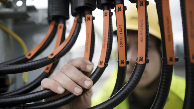 An engineer from EE the wireless network provider, owned by BT Group Plc, checks cabling on Huawei Technologies Co. 5G equipment undergoing trials in the City of London, U.K., on Friday, March 15, 2019. Europe would fall behind the U.S. and China in the race to install the next generation of wireless networks if governments ban Chinese equipment supplier Huawei Technologies Co. over security fears, according to an internal assessment by Deutsche Telekom AG. 