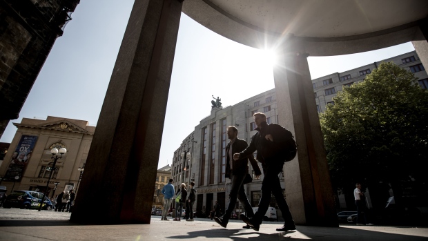 Pedestrians pass the headquarters of the Czech central bank (CNB) in Prague, Czech Republic, on Thursday, May 2, 2019. The Czech central bank raised interest rates to the highest in a decade as a persistently weak koruna adds to inflationary pressure. 