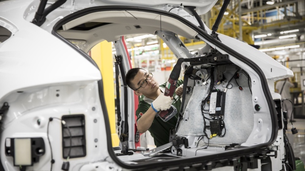An employee assembles a Jaguar E-Pace compact sport utility vehicle (SUV) on the production line at the second phase of the Chery Jaguar Land Rover Automotive Co. plant in Changshu, China, on Wednesday, June 27, 2018. Jaguar Land Rover is planning to build an electric vehicle in China as the iconic British manufacturer steps up its game in a fast-growing market where other luxury marques from Audi to Mercedes-Benz are plowing money to gain leadership. 