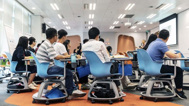New employees attend a class at Huawei University, a company training facility in Dongguan, China, on May 23. Photographer: Qilai Shen/Bloomberg