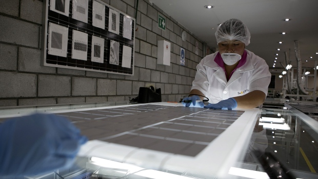 An employee solders photovoltaic panels at a Solartec SA renewable energy assembly plant in Irapuato, Mexico. 