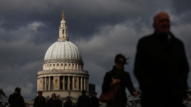 Pedestrians battle high winds as they cross Millennium Bridge in view of St Paul's Cathedral as the Storm Doris weather front hits London, U.K., on Thursday, Feb. 23, 2017. The U.K.'s withdrawal from the European Union will be expensive for Britain, Austrian Chancellor Christian Kern said. 