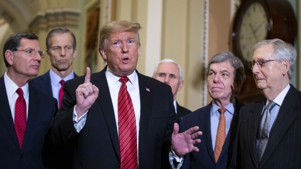 U.S. President Donald Trump, center, speaks to members of the media following a Senate Republicans policy luncheon at the U.S. Capitol in Washington, D.C., U.S., on Wednesday, Jan. 9, 2019. Republican members of Congress are "very, very unified" behind continuing the partial government shutdown, Trump said after meeting with GOP senators. Photographer: Al Drago/Bloomberg